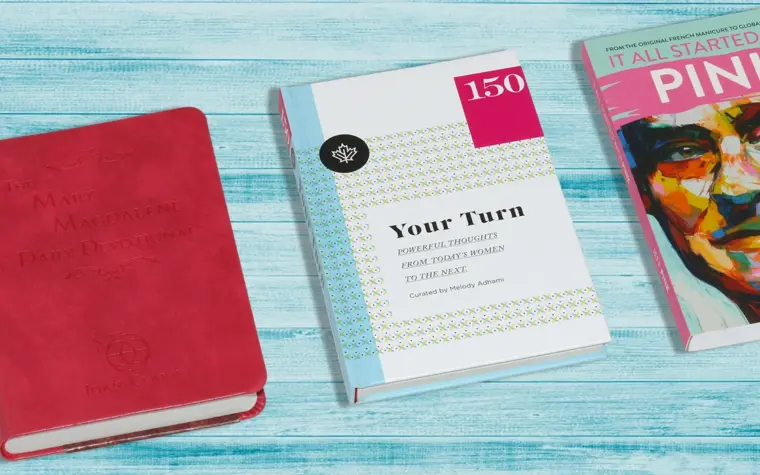 A slim paperback resting beside a thick hardcover novel on a wooden desk, illustrating novella vs novel length
