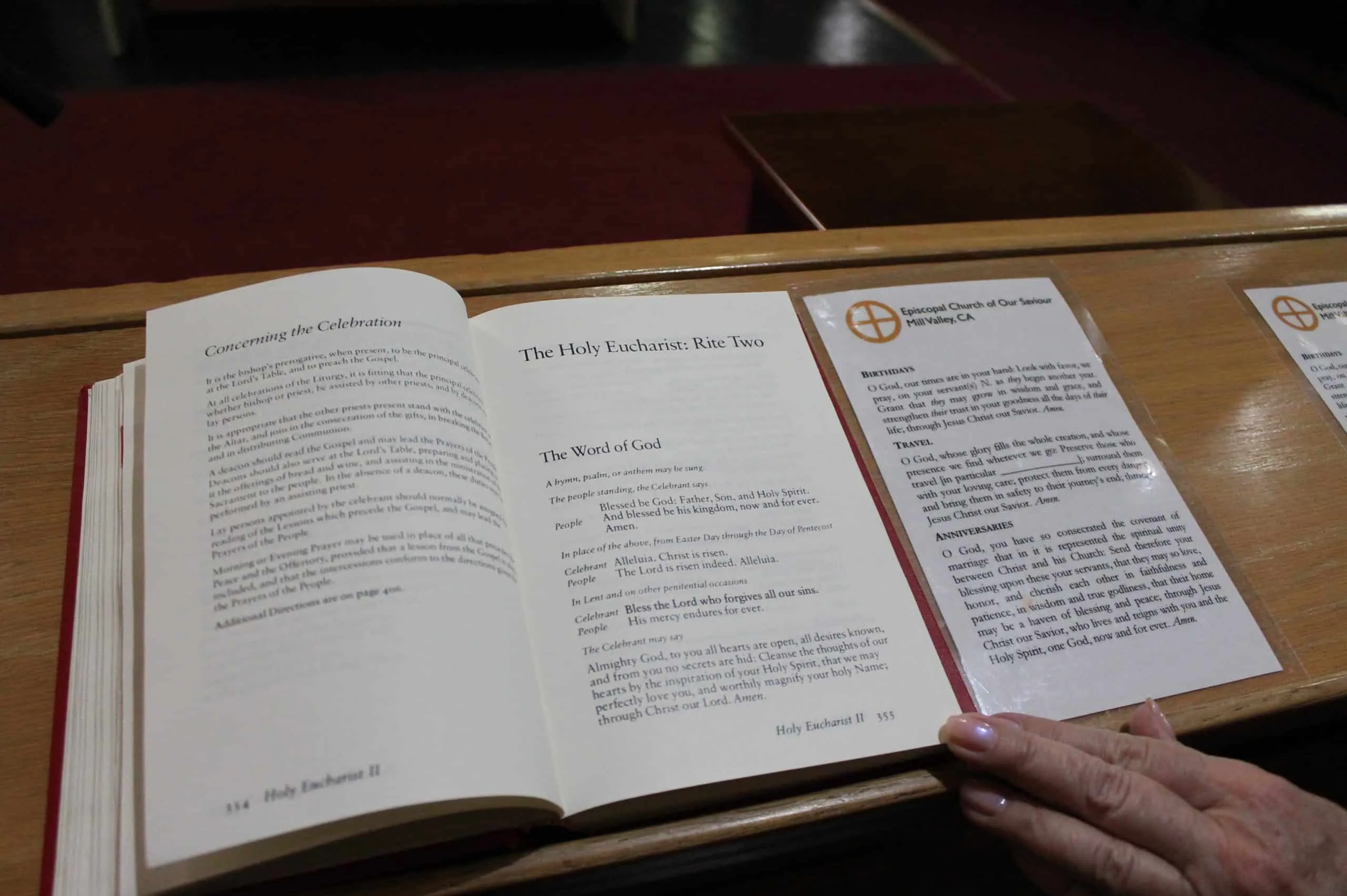 Open hymnal on a wooden stand showing a hymn's repeated verses, illustrating strophic form in music
